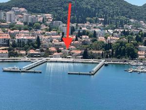 an aerial view of a city with a red arrow at Apartments MoniDuL in Dubrovnik