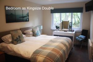 a bedroom as kingsize double with a bed and a window at The Cabin at Easter Arr in Auldearn