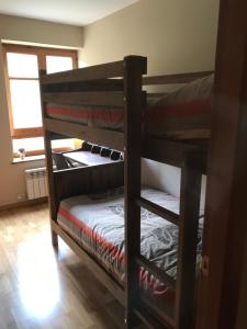 two bunk beds in a room with a window at Apartament de Luxe a Port del Comte in La Coma i la Pedra
