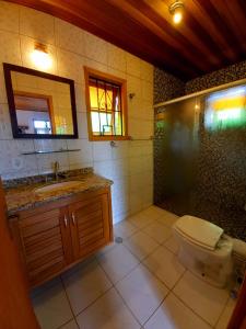 a bathroom with a toilet and a shower and a sink at Claire Cottage in Monte Verde +26 photos