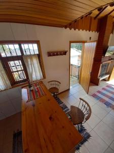 a large wooden table in a room with chairs at Claire Cottage in Monte Verde