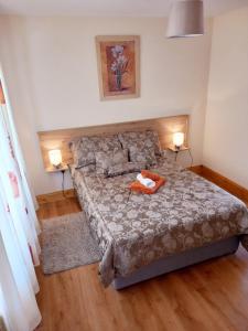 a bedroom with a bed with a stuffed animal on it at A New U Country Cottage Apartment 2 in Valentia Island