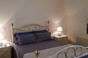 a bedroom with a bed with blue pillows and two night stands at Casa Bento Moura Portugal in Moimenta da Serra