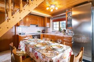 a kitchen with a table with plates and glasses on it at Villa Nicole in Theológos +27 photos