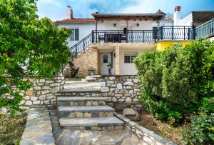 a house with a stone staircase leading to the front yard at Villa Nicole in Theológos