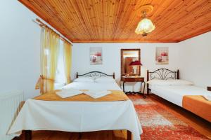 a bedroom with two beds and a wooden ceiling at Villa Nicole in Theológos