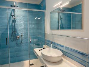 a bathroom with a sink and a shower at 103 Boutique Hotel Stintino in Stintino