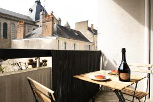 a bottle of wine sitting on a table on a balcony at Le Grand Chambord in Laval