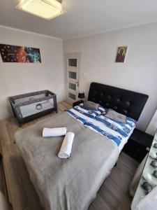 sypialnia z dużym łóżkiem z dwoma ręcznikami w obiekcie Apartament ALEX we Władysławowie