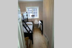 a small room with two bunk beds and a window at Apartment Gaustablikk in Gaustablikk