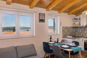a living room with a table and a couch at The Rooftop Apartment Punat in Punat