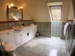 a bathroom with a sink and a mirror and a shower at Ardno House B & B in Glencoe