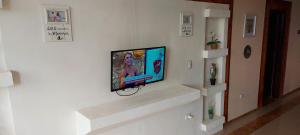 a flat screen tv hanging on a wall at El Castillo Monte Campana in Puntarenas