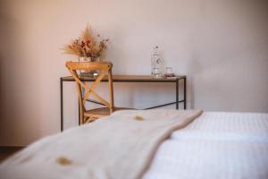 a bedroom with a table and a bed with a chair at Hotel Splendide in Champex