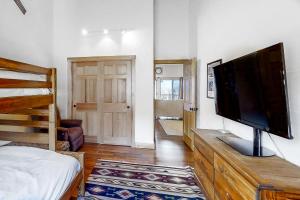 a bedroom with a flat screen tv on a wooden dresser at Linderhof Mountainside 12 in Bartlett