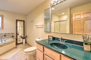 a bathroom with a sink and a toilet at Cozy Dam Lake Escape with Dock, Yard and Water Access! in Eagle River +25 photos