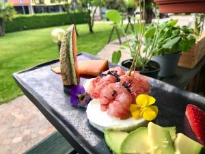 a plate of food with shrimp and vegetables on a table at Poli Hotel in San Vittore Olona