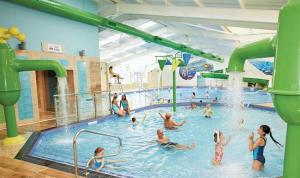 a group of people in a swimming pool at Pine Drive Golden Sands Mablethorpe in Mablethorpe