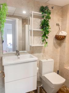 a bathroom with a white sink and a toilet at Apartamento Narváez- Altos Del Tomillar in Torre del Mar