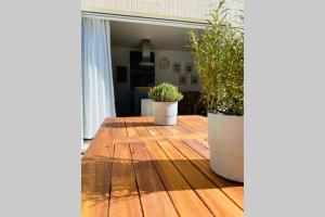 two potted plants sitting on top of a wooden floor at Luxury Apartment-Golden Triangle, Parking & Garden in Norwich