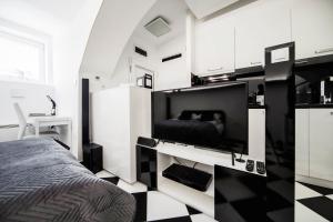 a bedroom with a bed and a black and white checkered floor at Black and White Studio in Ljubljana