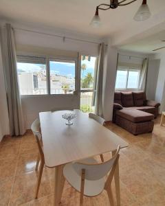 a living room with a table and a couch at 2ºA Escobar in Nerja