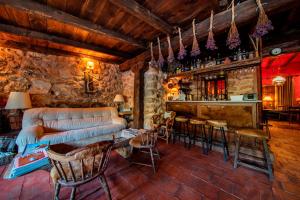 a living room with a couch and a bar at Royo Guarde, junto al río Mundo in Riópar