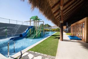 a water slide in a swimming pool with a water park at Dreams Onyx Resort & Spa - All Inclusive in Punta Cana