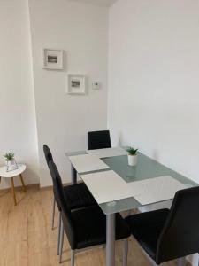 a dining table with black chairs and a table and a table and chairsktop at Apartmán Frymburk 30 in Frymburk
