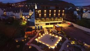 an overhead view of a building with lights at night at Boutique Hotel Moselgarten in Bullay