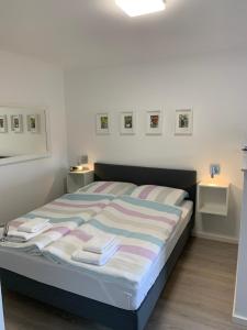 a bedroom with a bed with towels on it at Seeblick Labud 20 Bosau in Bosau