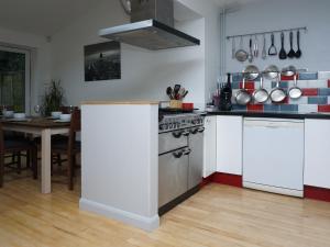 a kitchen with white appliances and a table with a dining room at Cornwallis House in Oxford