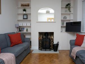 a living room with two couches and a fireplace at Cornwallis House in Oxford