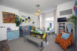 a living room with a couch and a table at Enjoy Ventnor 1, Pier Street, Wightlink offer in Ventnor