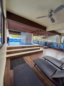 a living room with chairs and a ceiling fan at Hotel Diamante in Santa Cruz Huatulco