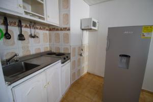 a kitchen with a sink and a refrigerator at Toscana Suite 10-18 in Cartagena de Indias