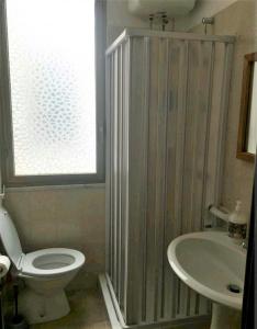 a bathroom with a toilet and a sink at Appartamento in centro in Lampedusa