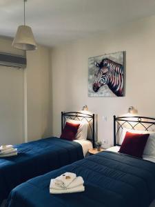 Postel nebo postele na pokoji v ubytování Costas Rooms