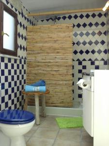 a bathroom with a toilet and a table and a tub at Casa Uldina in Bombarral +52 photos