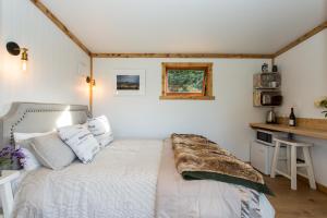 a bedroom with a bed with a blanket on it at The Kanuka Cabin in Wanaka