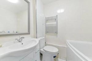 a white bathroom with a sink and a toilet at Brunswick Rooms in Sutton