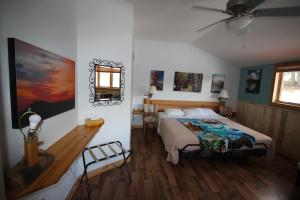 a bedroom with a bed and a ceiling fan at York Creek Bed & Breakfast in Coleman