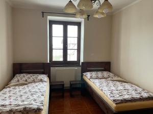 A bed or beds in a room at Četnická stanice Hluboká
