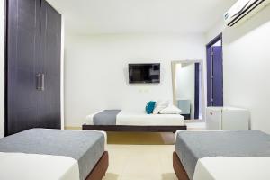 TV a/nebo společenská místnost v ubytování Hotel Ayenda Monteria Central