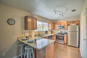 a kitchen with wooden cabinets and a white refrigerator at Modern North Port Gem Near Beaches, Golf, and Shops! in North Port