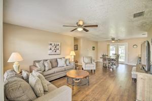 a living room with a couch and a ceiling fan at Modern North Port Gem Near Beaches, Golf, and Shops! in North Port