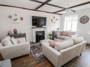 a living room with two couches and a fireplace at Martingale in Torquay