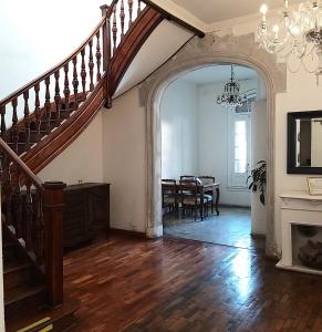 a living room with a staircase and a dining room at 515 St. Patrick Guesthouse Hotel in Buenos Aires