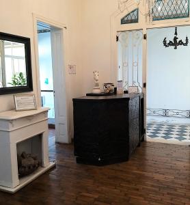 a living room with a fireplace and a black cabinet at 515 St. Patrick Guesthouse Hotel in Buenos Aires