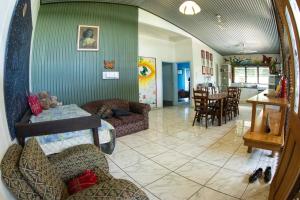 a living room with a couch and a dining room at Batchelor Butterfly Farm in Batchelor